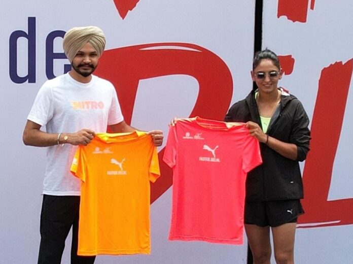 Delhi Half Marathon 2024 race day tees are introduced by Sarabjot Singh and Harmanpreet Kaur.